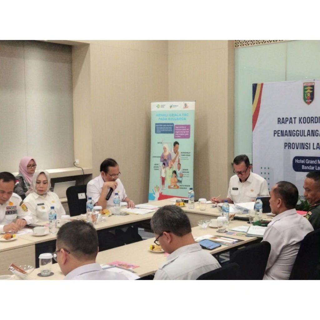 Kepala Dinas Kesehatan Provinsi Lampung (Memgang Mic) saat melakukan pemaparan bersaa dengan seluruh peserta kepada Sekretairis Daerah Provinsi Lampung (Dekat Banner Pertemuan)